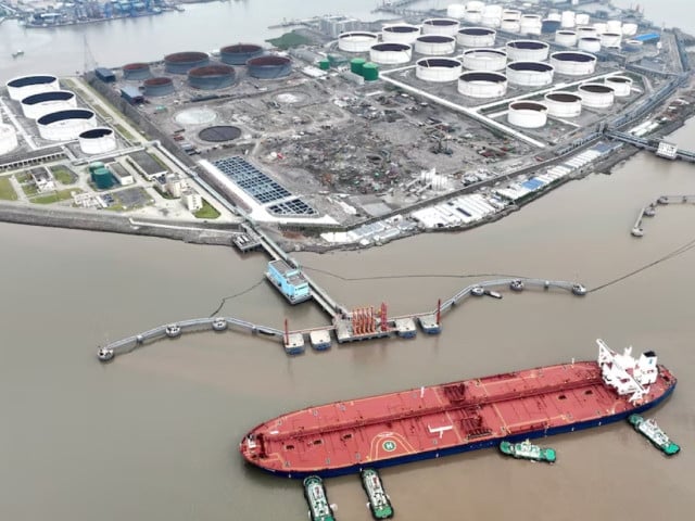 an aerial view shows tugboats helping a crude oil tanker to berth at an oil terminal off waidiao island in zhoushan zhejiang province china july 18 2022 photo via reuters